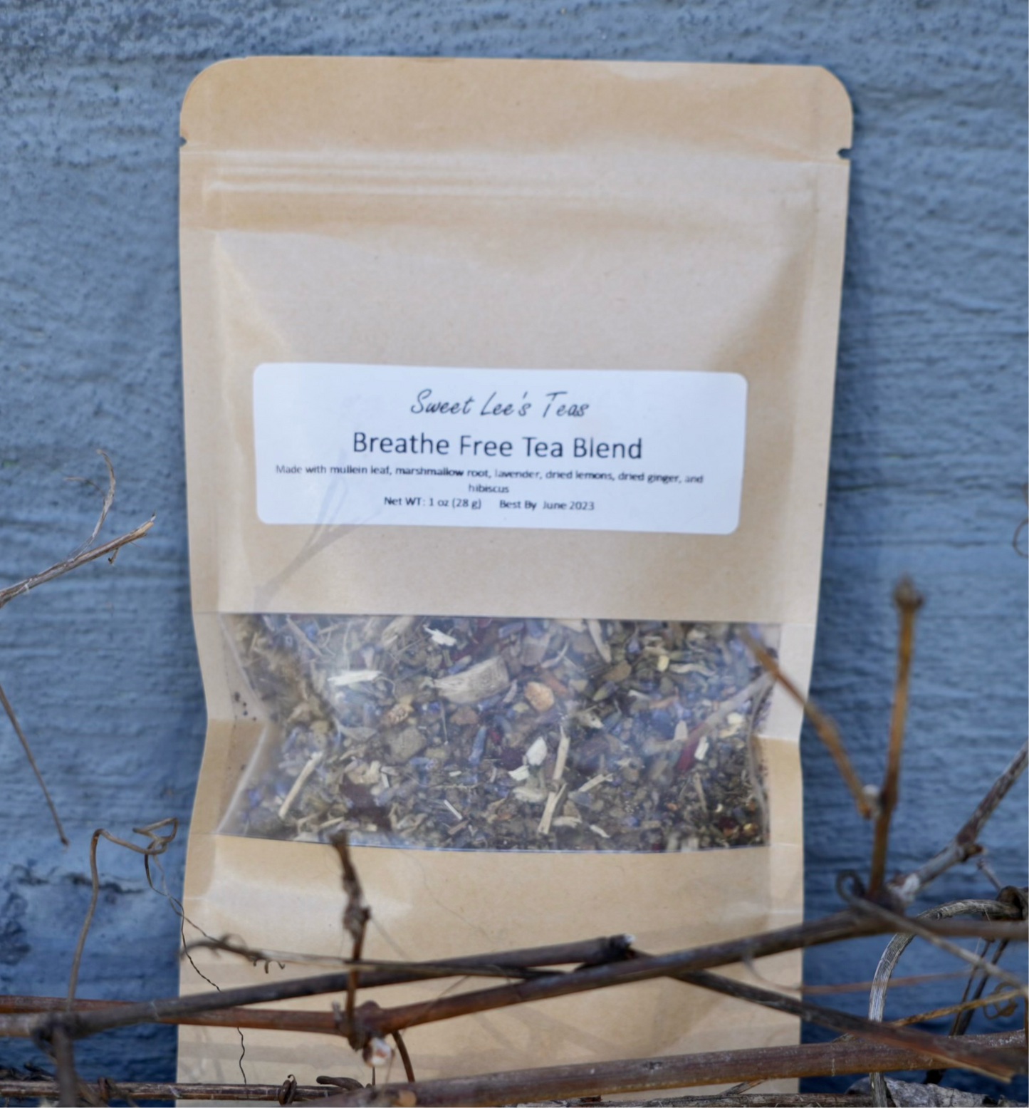 Breathe Free Tea Blend natural herbal tea, crafted for lung health, displayed against a textured stone wall with dried botanicals."