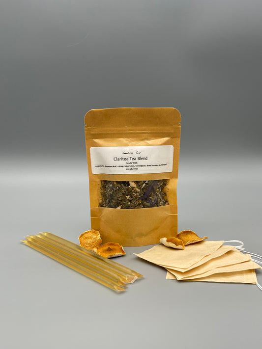Sweet Lee’s Teas Iced Tea Kit featuring a kraft bag of Claritea Tea Blend, natural honey sticks, reusable tea bags, and dried citrus slices, providing everything needed for brewing refreshing iced tea.